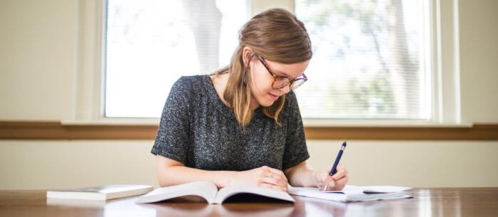 Woman studying at a table.