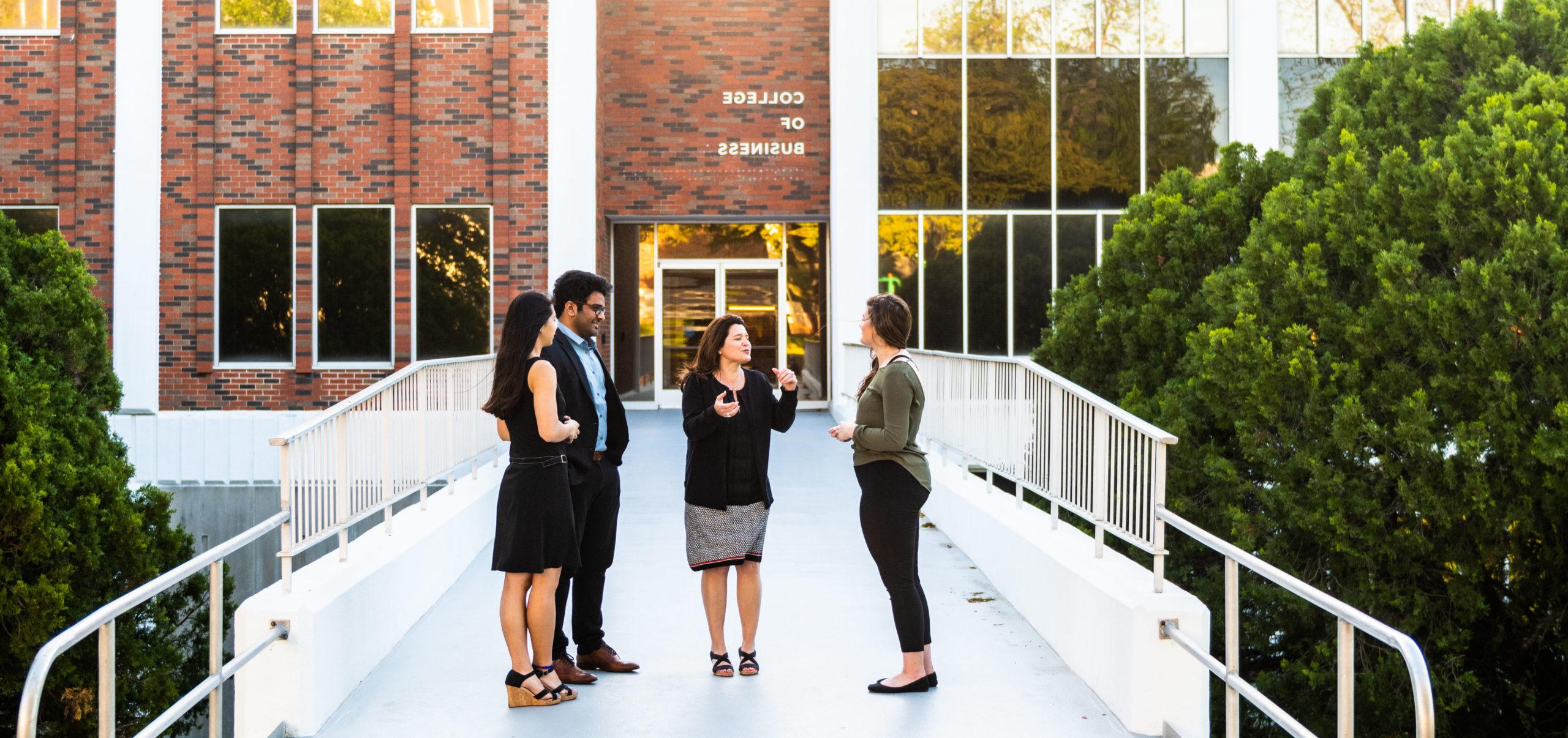 Group standing in front of the College of Business.